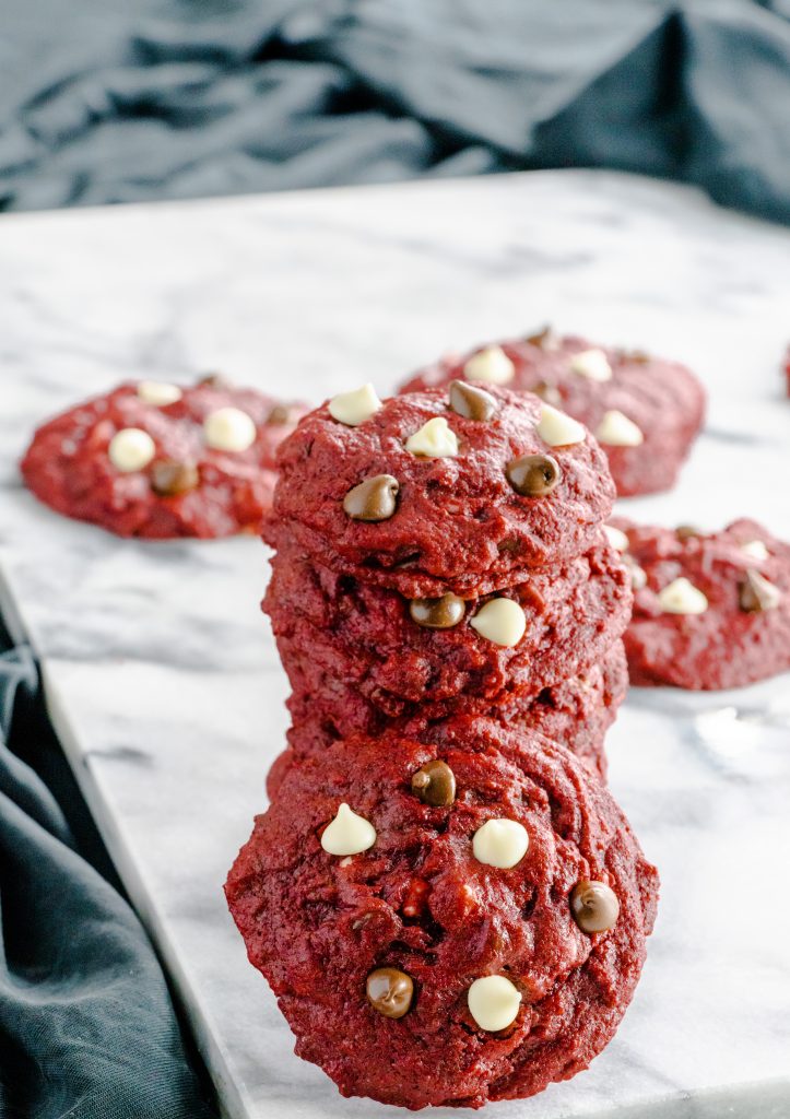 Stacked red velvet chocolate chip cookies. 