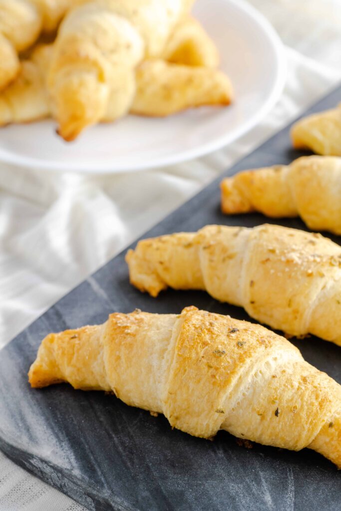 Garlic & cheese crescent rolls on a marble board. 