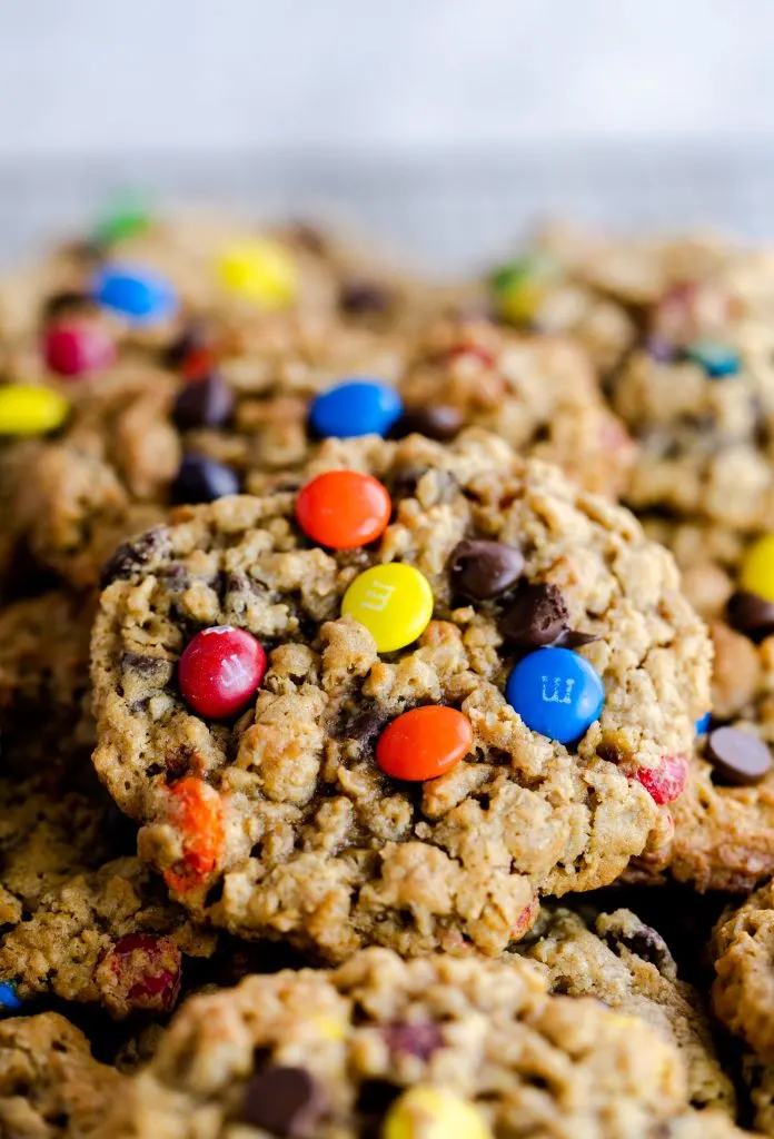 Layered monster cookies topped with chocolate chips and M&M's. 