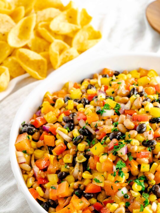 A large bowl of cowboy caviar topped with fresh cilantro.