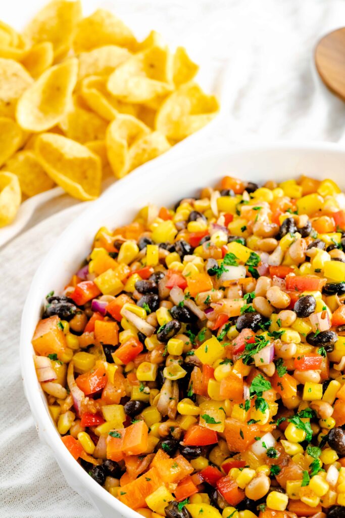 Bowl of black bean corn salad with fresh cilantro sprinkled on top. 