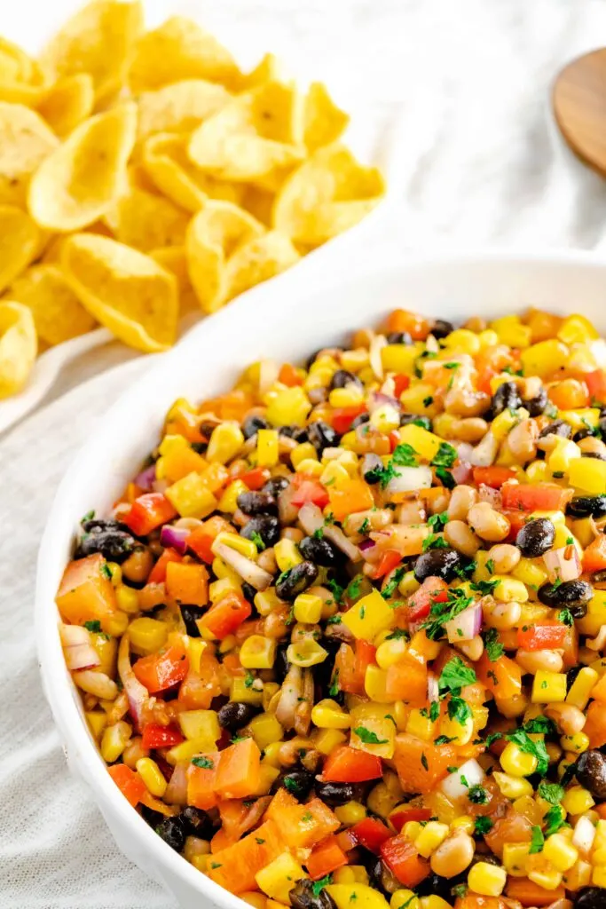 Bowl of black bean corn salad with fresh cilantro sprinkled on top. 