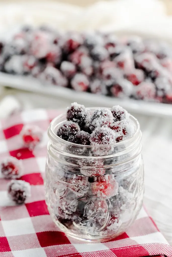 Frosted cranberries in a small mason jar. 