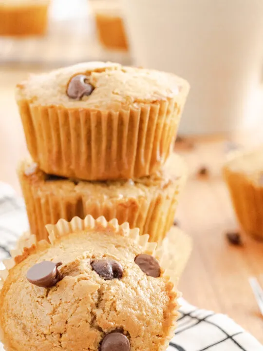Three cappuccino muffins on a napkin with a muffin propped in front.