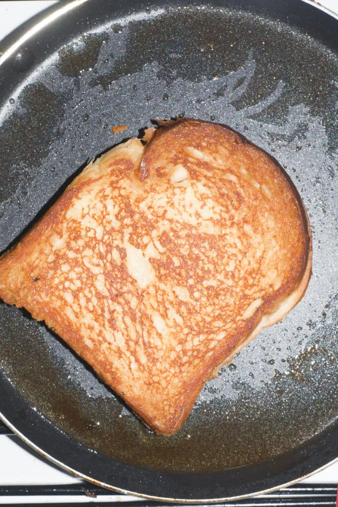 French toast in skillet frying. 