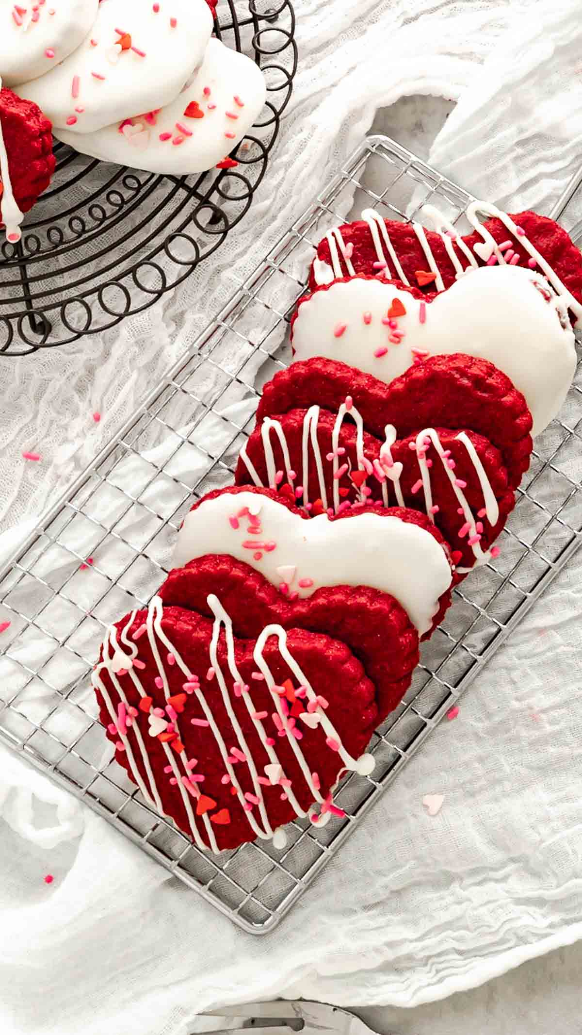 Heart shaped red velvet shortbread cookies decorated for Valentine's Day.