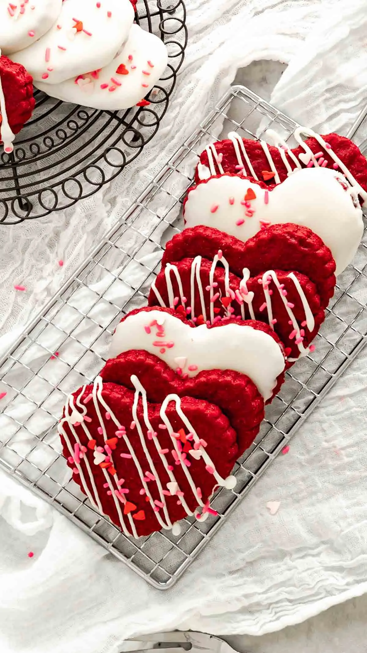 Heart shaped red velvet shortbread cookies decorated for Valentine's Day.