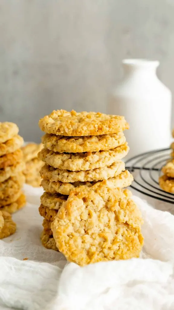 A stack of Cracker Jack Cookies with a white drinking jug in the background.