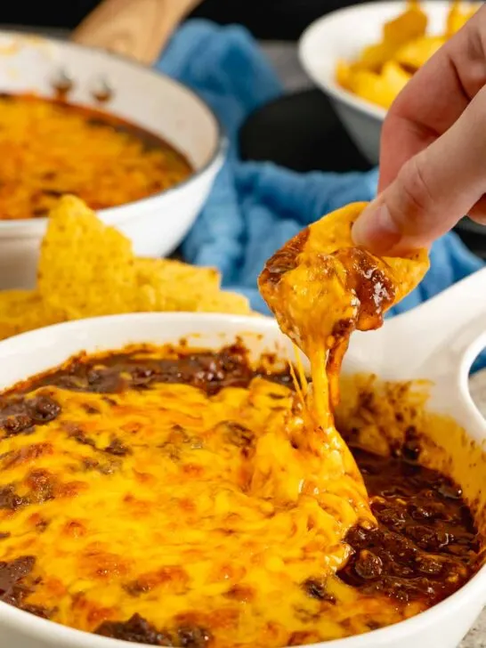 A Frito scoop filled with Cincinnati Style Chili dip.
