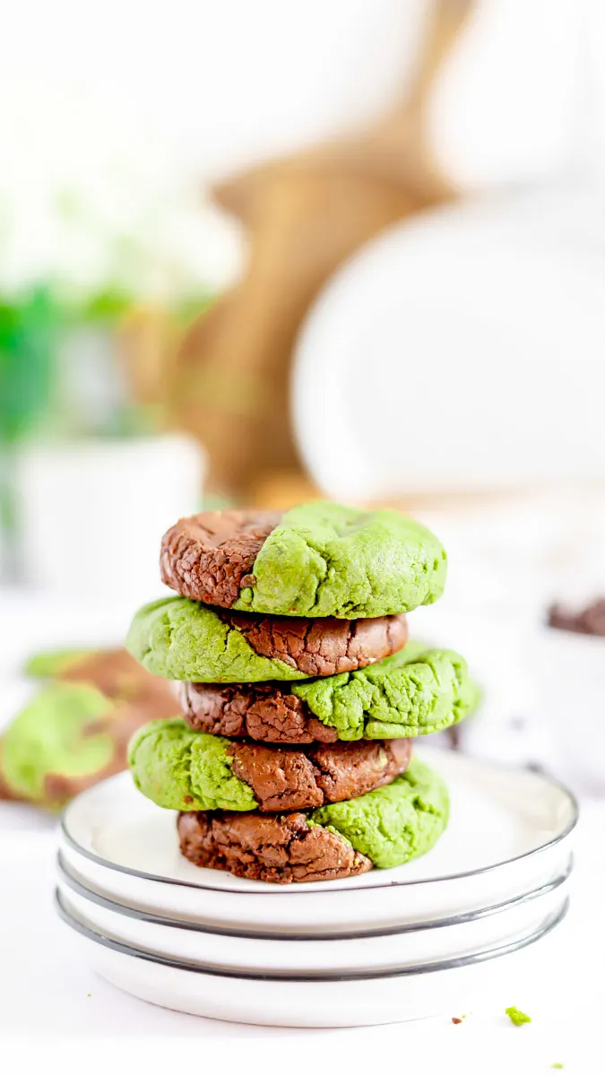 A stack of matcha brookies on a stack of plates.